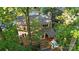 A home is nestled in a lush landscape and boasts a back deck with a hot tub and mature trees at 9002 Maple Hill Ct, Huntersville, NC 28078