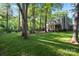 Private backyard view with a deck, hot tub, patio, and plenty of green space surrounded by trees at 9002 Maple Hill Ct, Huntersville, NC 28078