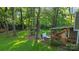 The backyard features a hot tub on a deck, a seating area, and an expansive yard with mature trees at 9002 Maple Hill Ct, Huntersville, NC 28078