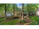 Spacious backyard featuring a large deck, mature trees, and ample green space at 9002 Maple Hill Ct, Huntersville, NC 28078