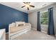 Cozy bedroom with a blue accent wall, a pullout twin bed, and natural light from the window at 9002 Maple Hill Ct, Huntersville, NC 28078