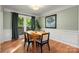 Dining room with hardwood floors, wainscoting, natural light, and modern decor at 9002 Maple Hill Ct, Huntersville, NC 28078