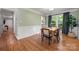 Dining room featuring hardwood floors, wainscoting, and large windows at 9002 Maple Hill Ct, Huntersville, NC 28078