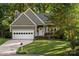 Charming home with a well-maintained lawn, two-car garage, and inviting front entrance at 9002 Maple Hill Ct, Huntersville, NC 28078