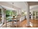 Eat-in kitchen with hardwood floors, stainless appliances, and abundant natural light at 9002 Maple Hill Ct, Huntersville, NC 28078