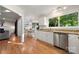 Kitchen with white cabinets, granite counters, stainless dishwasher, and hardwood floors at 9002 Maple Hill Ct, Huntersville, NC 28078
