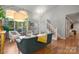 Bright and airy living room with stairs, featuring hardwood floors and stylish decor at 9002 Maple Hill Ct, Huntersville, NC 28078