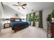Spacious primary bedroom with large windows and a ceiling fan at 9002 Maple Hill Ct, Huntersville, NC 28078