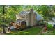Home exterior featuring a well-maintained lawn, a wooden deck with a hot tub, and serene surroundings at 9002 Maple Hill Ct, Huntersville, NC 28078