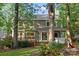 The rear of the home features a deck with steps to the yard, surrounded by mature trees at 9002 Maple Hill Ct, Huntersville, NC 28078