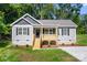 Charming one story home with a covered front porch, gray siding, black shutters, and green lawn at 951 Hardin Dr, Shelby, NC 28150