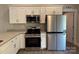 Bright kitchen featuring stainless steel appliances, granite countertops, and white cabinets at 951 Hardin Dr, Shelby, NC 28150
