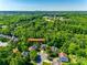 Aerial view showing property location in wooded area just outside the city at 9700 Stewart Spring Ln, Charlotte, NC 28216