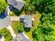 Aerial view of a home in a lush, maturely wooded neighborhood with manicured lawns at 9700 Stewart Spring Ln, Charlotte, NC 28216
