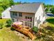 Aerial view of a deck, showing a large area for entertaining, surrounded by a large, manicured lawn at 9700 Stewart Spring Ln, Charlotte, NC 28216