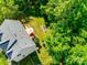 Overhead view featuring the home with lush backyard and deck surrounded by mature trees at 9700 Stewart Spring Ln, Charlotte, NC 28216