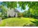 Beautifully maintained yard with mature trees and a spacious deck, ideal for outdoor living at 9700 Stewart Spring Ln, Charlotte, NC 28216