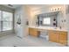 Bright bathroom with double sinks, generous counter space, and a large mirror at 9700 Stewart Spring Ln, Charlotte, NC 28216