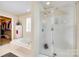Bathroom featuring a bathtub, separate shower, and walk-in closet at 9700 Stewart Spring Ln, Charlotte, NC 28216
