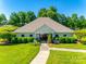 Community Clubhouse with landscaping, green grass, and bench at 9700 Stewart Spring Ln, Charlotte, NC 28216