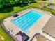 Aerial view of the neighborhood swimming pool with lounge chairs and covered tables at 9700 Stewart Spring Ln, Charlotte, NC 28216
