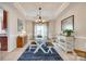 Bright dining room with a stylish light fixture and ample natural light from the large window at 9700 Stewart Spring Ln, Charlotte, NC 28216