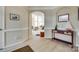 Spacious foyer with light wood floors, leading to a bright and open living area with tall windows at 9700 Stewart Spring Ln, Charlotte, NC 28216