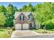 Attractive brick home with a two-car garage, lush green lawn, mature trees, and a cul-de-sac street at 9700 Stewart Spring Ln, Charlotte, NC 28216