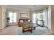 Cozy living room featuring large windows with sheer curtains and neutral tones for a relaxing atmosphere at 9700 Stewart Spring Ln, Charlotte, NC 28216