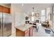 Open concept living area showcasing a kitchen island, dining area, and living room with high ceilings and natural light at 9700 Stewart Spring Ln, Charlotte, NC 28216