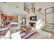 Open-concept living area with a view of the kitchen, featuring high ceilings, a fireplace, and a comfortable living room at 9700 Stewart Spring Ln, Charlotte, NC 28216