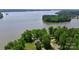 Aerial view of a beautiful lake with a home nestled among mature trees on the waterfront at 993 Jackson Rd, Fort Lawn, SC 29714