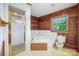 Bathroom featuring tile shower, wood-paneled walls, and a bathtub, creating a relaxing space at 993 Jackson Rd, Fort Lawn, SC 29714