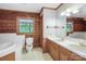 Traditional bathroom with wood paneling, double vanity, and a garden tub at 993 Jackson Rd, Fort Lawn, SC 29714