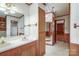 Bathroom with double sink vanity and walk-in closet with mirrored doors at 993 Jackson Rd, Fort Lawn, SC 29714