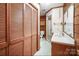 Bathroom features a wood-paneled wall, with a built-in vanity and ample storage within the closet at 993 Jackson Rd, Fort Lawn, SC 29714
