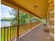 Relaxing covered porch with a scenic lake view and plenty of room for seating at 993 Jackson Rd, Fort Lawn, SC 29714