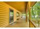 Cozy covered porch with wood floors and views of the trees at 993 Jackson Rd, Fort Lawn, SC 29714