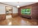 Formal dining room with hardwood floors, wood-paneled walls, and large window at 993 Jackson Rd, Fort Lawn, SC 29714