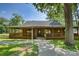 Charming log cabin with a covered porch, mature trees, and a well-manicured lawn at 993 Jackson Rd, Fort Lawn, SC 29714