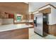 Kitchen area with a stainless steel refrigerator, breakfast bar, and wood cabinetry, offering a functional space at 993 Jackson Rd, Fort Lawn, SC 29714
