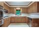 Charming kitchen featuring wood cabinets, stainless steel appliances, and a bright window overlooking the outdoors at 993 Jackson Rd, Fort Lawn, SC 29714