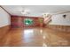 Bright living room features hardwood floors, wood-paneled walls, and staircase at 993 Jackson Rd, Fort Lawn, SC 29714
