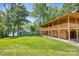 Log cabin with covered porch and a garage, surrounded by trees at 993 Jackson Rd, Fort Lawn, SC 29714