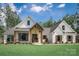Stunning two-story farmhouse with white siding, wooden accents, and a well-manicured lawn at 0 Ellis Spring Ct, Albemarle, NC 28001