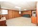 Finished basement with wood paneling, carpet flooring, and a cozy seating area at 1004 Midwood Dr, Monroe, NC 28112