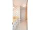 Bathroom with floral wallpaper, bathtub, and white vanity with peachy-pink countertop at 1004 Midwood Dr, Monroe, NC 28112