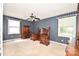 Spacious bedroom featuring wood furniture, ceiling fan, patterned wallpaper and two windows at 1004 Midwood Dr, Monroe, NC 28112