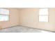 Bright bedroom featuring two windows providing natural light and neutral wall colors at 1004 Midwood Dr, Monroe, NC 28112