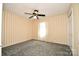 Bedroom boasting yellow striped walls, soft gray carpet and a ceiling fan at 1004 Midwood Dr, Monroe, NC 28112